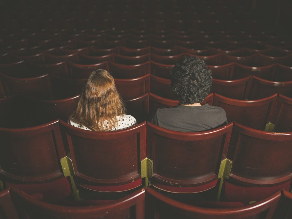 Young couple sitting in movie theater